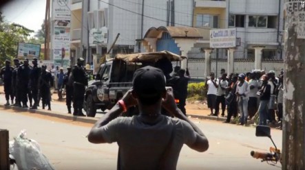 Cameroonian youth protesters being arrested and many look on